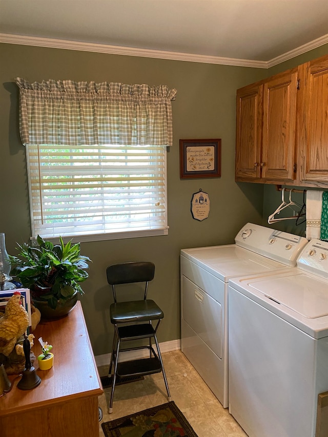 clothes washing area featuring washing machine and clothes dryer, cabinets, ornamental molding, and light tile patterned floors