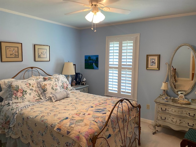 carpeted bedroom featuring ceiling fan and crown molding