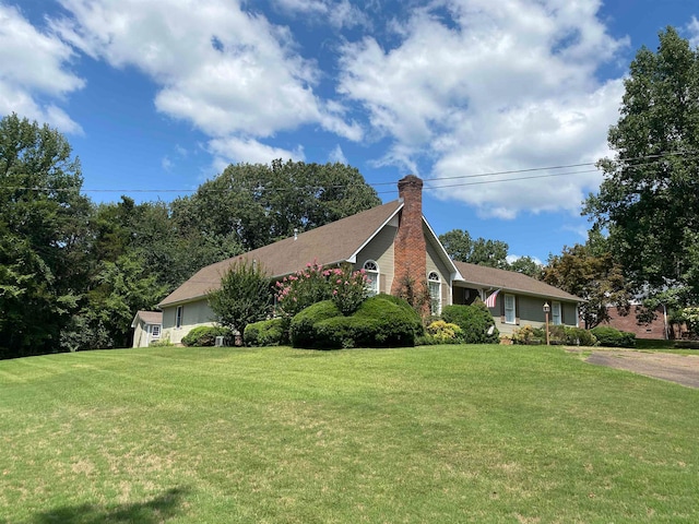 view of property exterior with a lawn