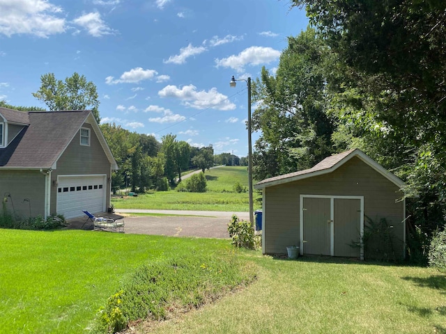 view of yard with a storage unit and a garage