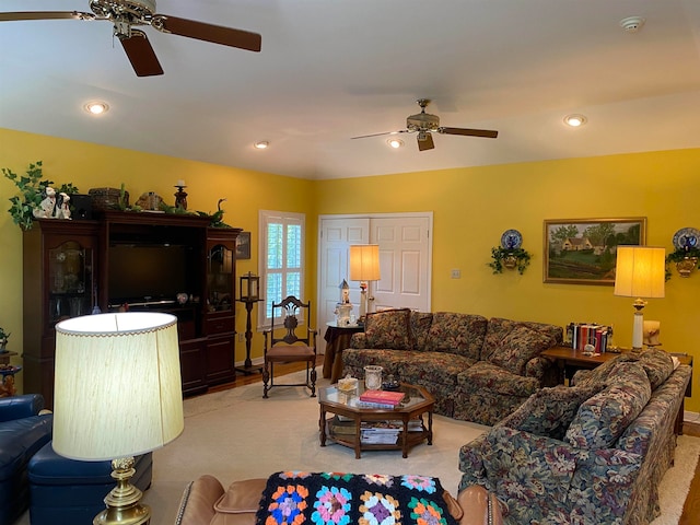 carpeted living room with ceiling fan