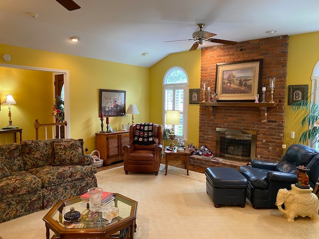 living room with lofted ceiling, light colored carpet, ceiling fan, and a fireplace