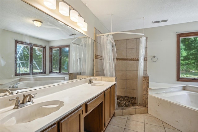 bathroom featuring vanity, a textured ceiling, independent shower and bath, and tile patterned flooring