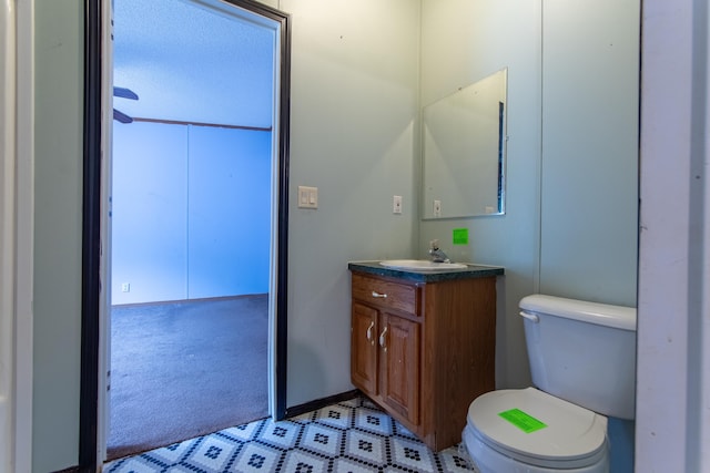 bathroom featuring toilet and vanity