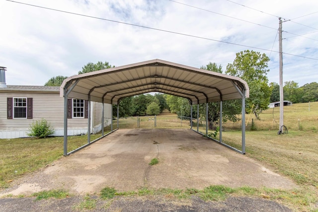 view of parking / parking lot with a lawn and a carport