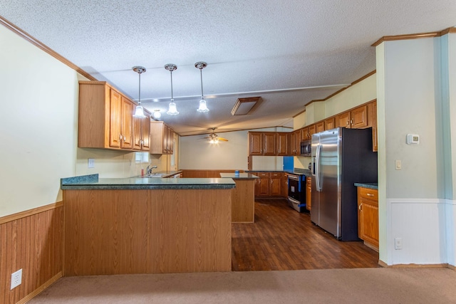 kitchen with pendant lighting, kitchen peninsula, dark hardwood / wood-style floors, and appliances with stainless steel finishes