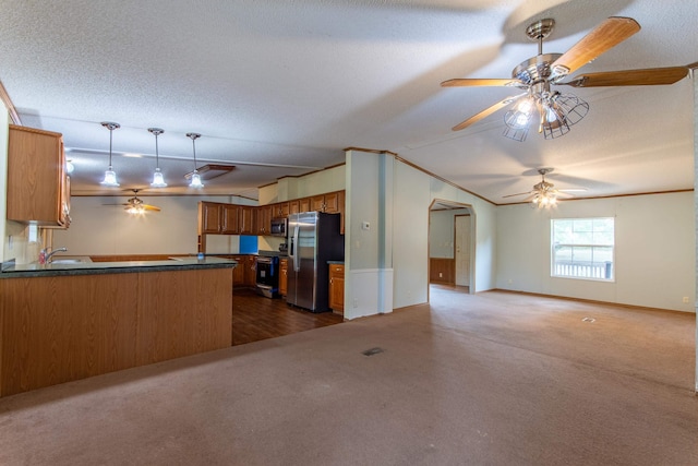 kitchen with appliances with stainless steel finishes, a textured ceiling, kitchen peninsula, and ceiling fan