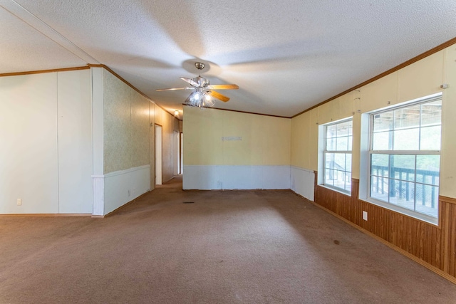 spare room with light carpet, crown molding, a textured ceiling, and ceiling fan