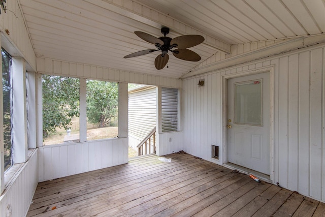 unfurnished sunroom featuring wood ceiling, lofted ceiling, a healthy amount of sunlight, and ceiling fan