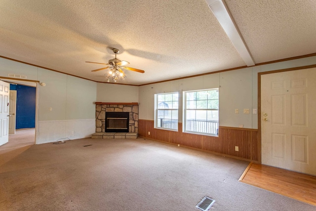 unfurnished living room with a fireplace, a textured ceiling, ceiling fan, and light hardwood / wood-style floors