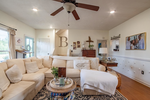 living room with ceiling fan and wood-type flooring