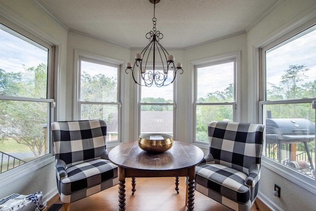 dining room with hardwood / wood-style floors, an inviting chandelier, crown molding, and a textured ceiling