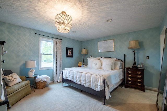 carpeted bedroom featuring a textured ceiling and a notable chandelier