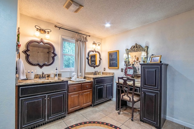 bathroom featuring tile patterned flooring, a textured ceiling, and vanity