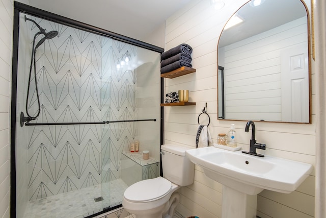 bathroom with toilet, sink, wooden walls, and walk in shower