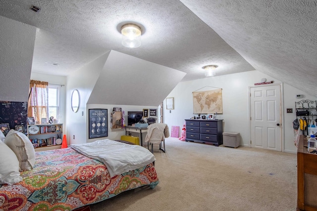 carpeted bedroom featuring vaulted ceiling and a textured ceiling