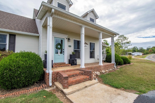 view of front of property with a front yard and covered porch