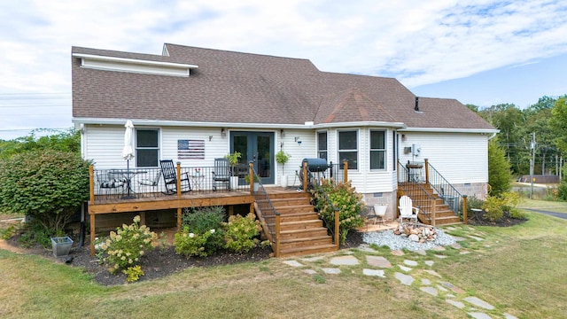 back of house featuring a wooden deck and a lawn