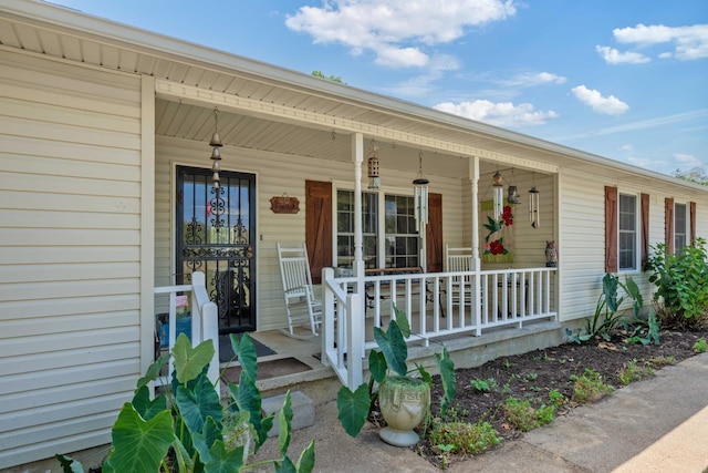 doorway to property featuring covered porch