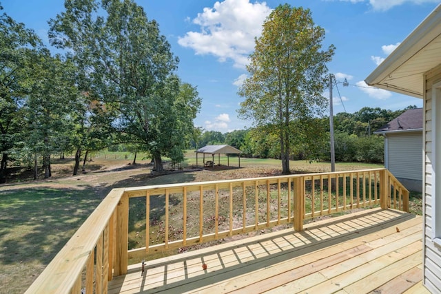 wooden deck featuring a gazebo and a lawn