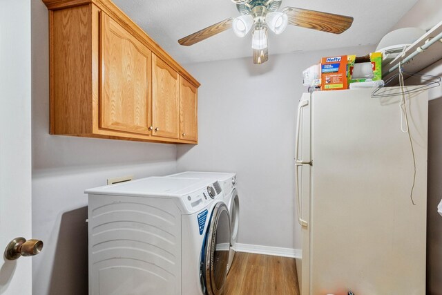 laundry area featuring light hardwood / wood-style flooring, cabinets, washer and dryer, and ceiling fan