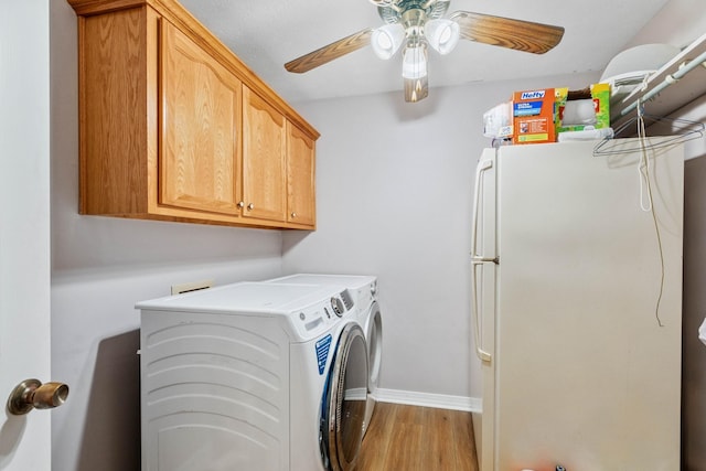 washroom with baseboards, ceiling fan, washing machine and dryer, light wood-style floors, and cabinet space