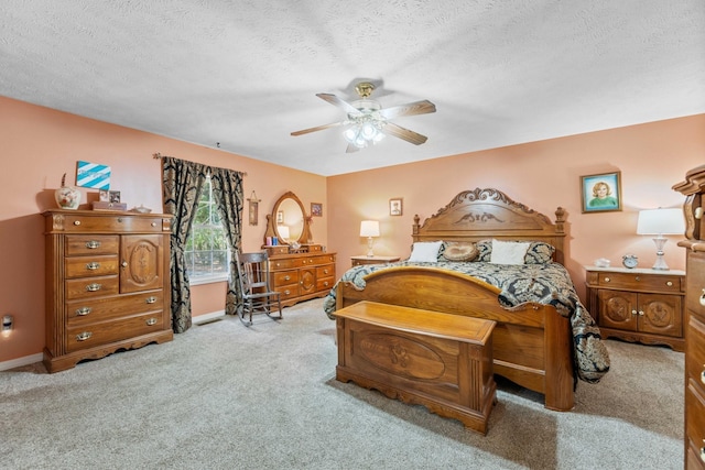 bedroom with baseboards, a textured ceiling, ceiling fan, and carpet