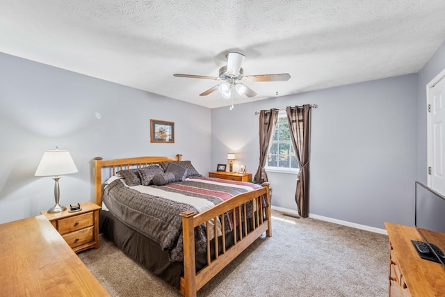 bedroom featuring baseboards, light colored carpet, ceiling fan, and a textured ceiling