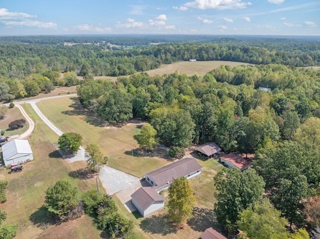 birds eye view of property featuring a view of trees