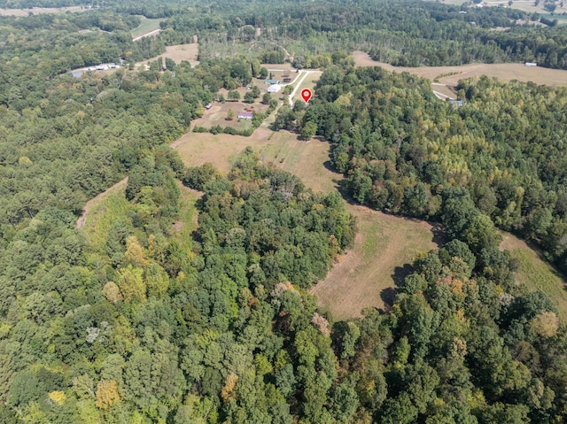 birds eye view of property featuring a view of trees