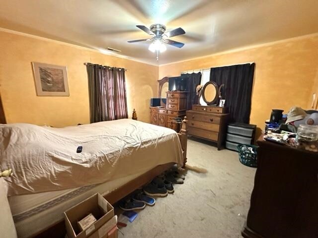 carpeted bedroom featuring ceiling fan