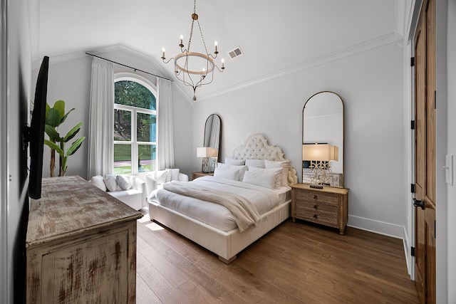 bedroom featuring visible vents, lofted ceiling, wood finished floors, an inviting chandelier, and baseboards