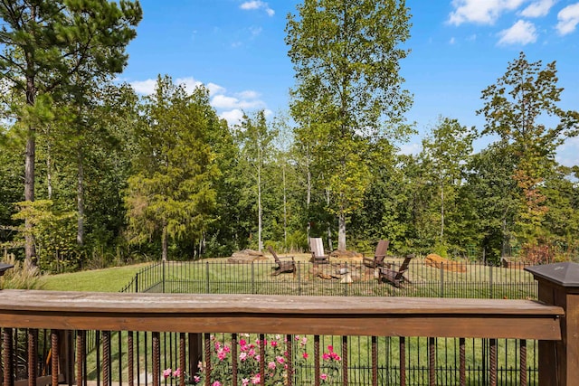 wooden deck with a yard and fence