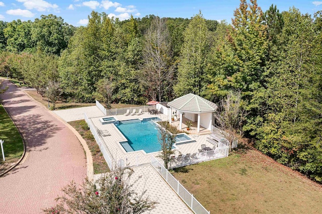 view of pool featuring a lawn, a storage structure, a fenced backyard, an outdoor structure, and a patio area