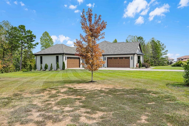 view of front of home featuring a garage, a front yard, driveway, and stucco siding