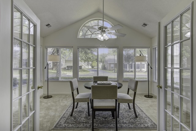 sunroom / solarium featuring visible vents, ceiling fan, and vaulted ceiling