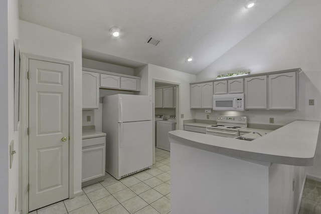 kitchen with visible vents, independent washer and dryer, white appliances, a peninsula, and light countertops