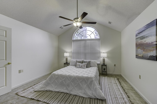 bedroom with visible vents, a textured ceiling, lofted ceiling, and carpet floors