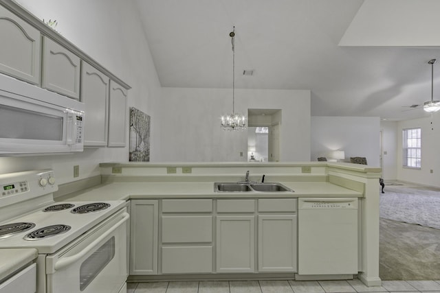 kitchen featuring a sink, open floor plan, white appliances, a peninsula, and light countertops