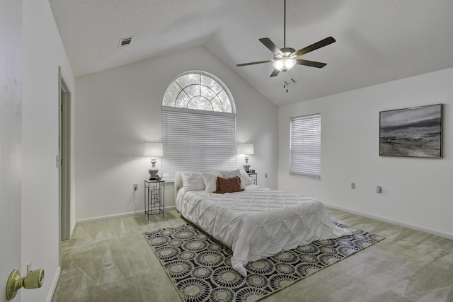 bedroom with visible vents, baseboards, lofted ceiling, a textured ceiling, and light colored carpet