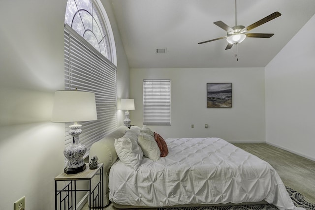 carpeted bedroom with visible vents, ceiling fan, baseboards, and lofted ceiling