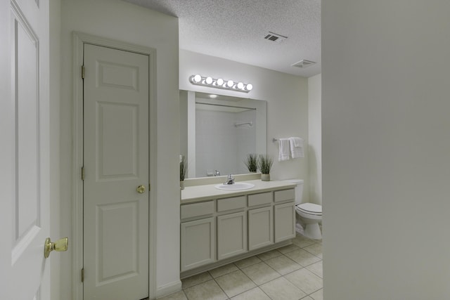 bathroom featuring vanity, visible vents, a textured ceiling, tile patterned floors, and toilet