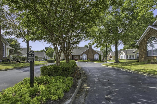 view of road featuring curbs and a residential view