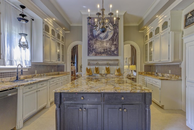 kitchen featuring crown molding, sink, pendant lighting, a kitchen island, and stainless steel dishwasher