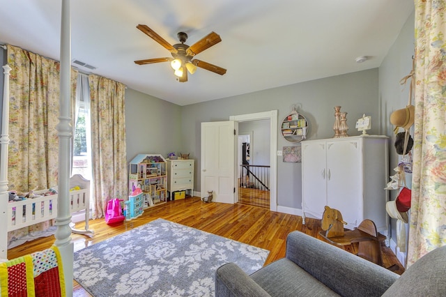 rec room with ceiling fan and light hardwood / wood-style floors