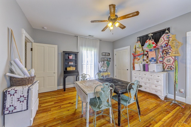 dining area featuring light wood-type flooring and ceiling fan