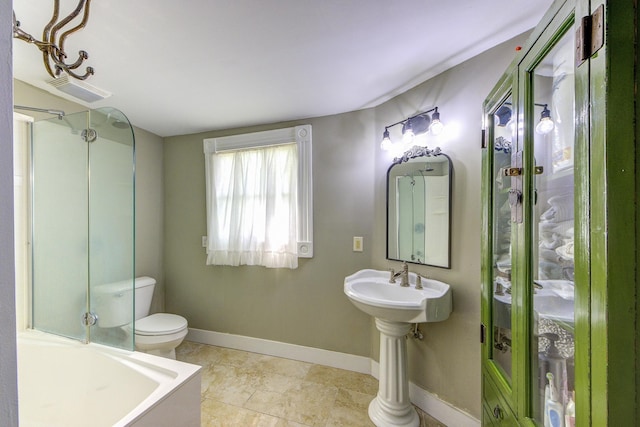 bathroom with tile patterned floors, toilet, and a shower with shower door