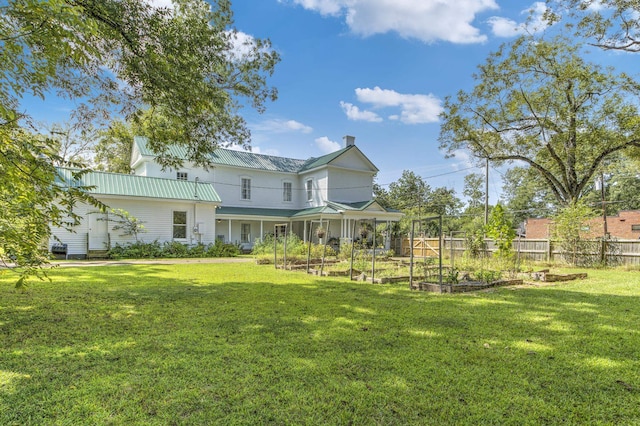 back of house featuring a lawn