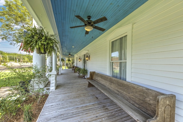 wooden terrace featuring ceiling fan and covered porch