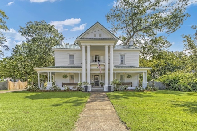 neoclassical / greek revival house with a front lawn, covered porch, and a balcony